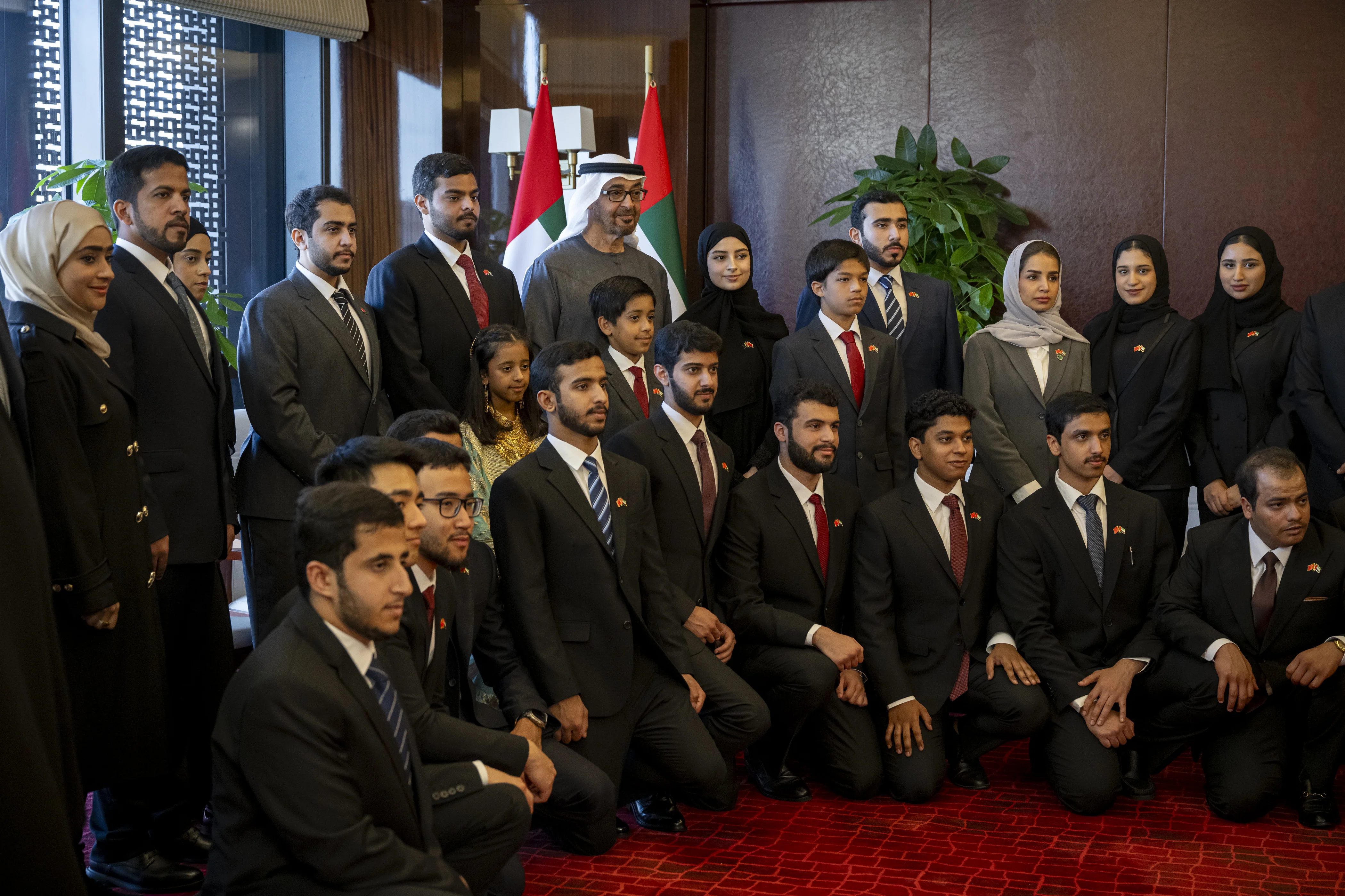 His Highness Sheikh Mohamed bin Zayed Al Nahyan, President of the United Arab Emirates, stands for a photograph with China-based Emirati students, during a state visit, May 2024