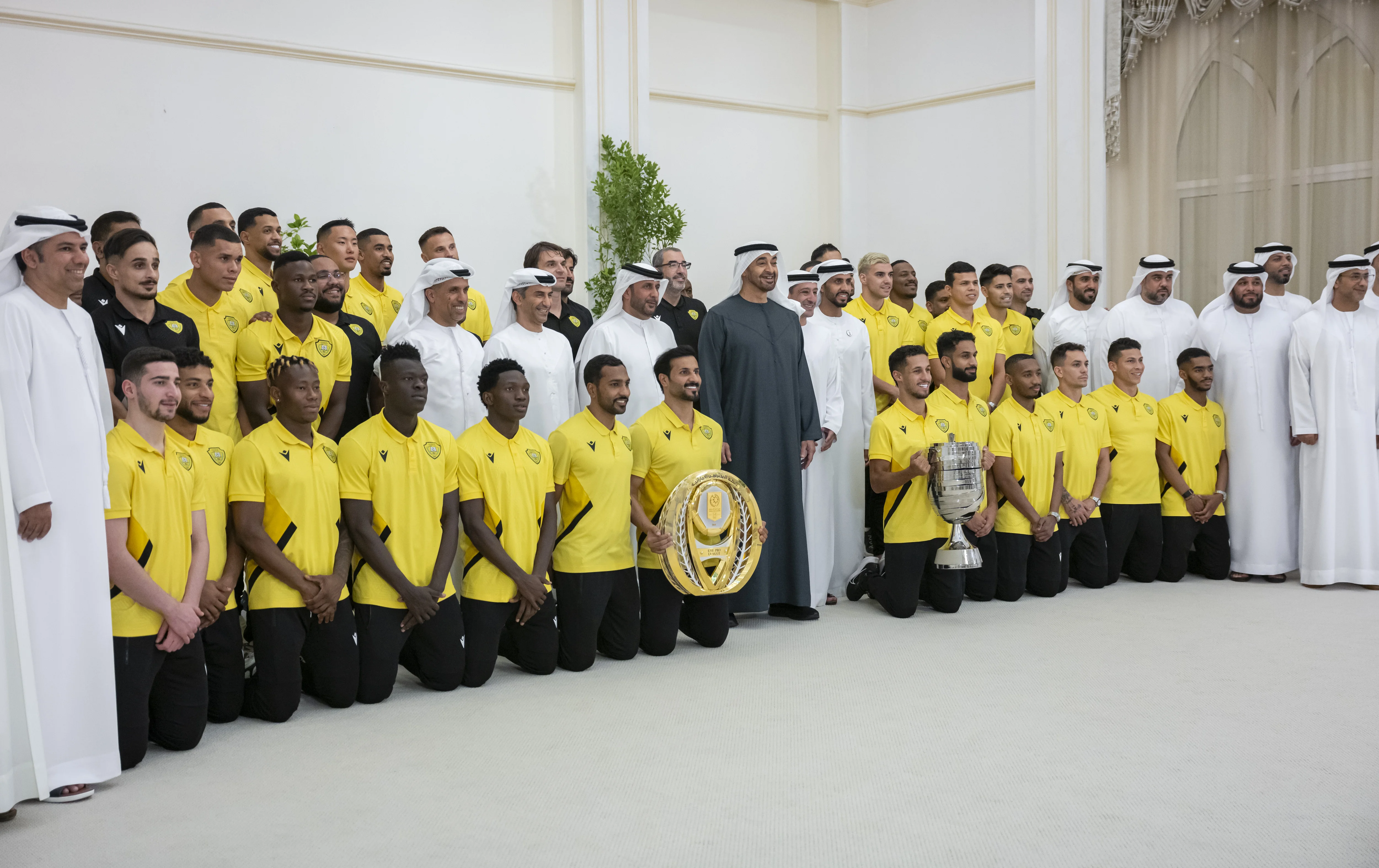 His Highness Sheikh Mohamed bin Zayed Al Nahyan, President of the United Arab Emirates, stands for a photograph with members of Al Wasl Club team, who recently won the UAE President's Cup and the ADNOC Pro League, during a Sea Palace barza, June 2024